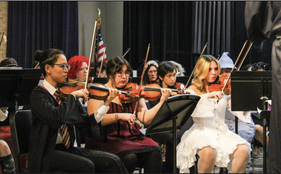 NE orchestra members Ariyan, Ava and Ayda Ashrafian participate in the orchestra concert’s costume competition. Other members preform pieces from “Sweeny Todd” by Stephen Sondheim.